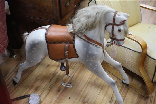 A dapple grey painted carved wood rocking horse, length 40in.